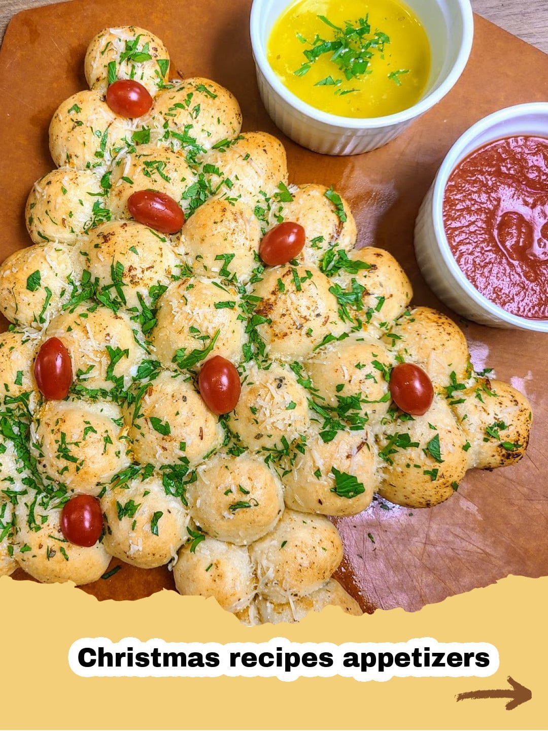 The Most Festive Christmas Tree Pull-Apart Bread: A Holiday Delight! 1 Festive Christmas Tree Pull-Apart Bread on a serving platter with marinara sauce.