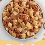 A large bowl of golden-brown Original Homemade Chex Party Mix, filled with mixed cereals, nuts, and pretzels.
