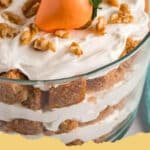 Beautifully layered Carrot Cake Trifle in a clear glass bowl, garnished with pecans and carrot curls.