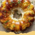Savory pull-apart Chicken Alfredo Monkey Bread in a bundt pan, garnished with fresh parsley.