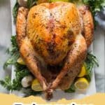 The Ultimate Easy, No Fuss Thanksgiving Turkey Recipe for a Stress-Free Holiday 5 A perfectly roasted golden-brown Thanksgiving turkey on a platter with herbs and lemons, ready to be carved.