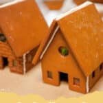 Bake Your Holiday Dreams: The Ultimate Homemade Gingerbread House Recipe 6 Beautifully decorated classic gingerbread house with white icing and colorful candies, set against a festive holiday background.