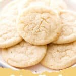A stack of golden-brown chewy sugar cookies on a wire rack with a few loose cookies scattered around, some coated in sparkling sugar.