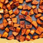 Close-up of perfectly caramelized roasted sweet potatoes with herbs