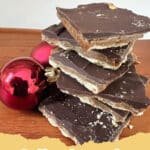 The Irresistible Magic of Julia's Christmas Crack: A Holiday Tradition You Need! 5 Close-up of Julia's Christmas Crack with a golden toffee base, melted chocolate, and a sprinkle of flaky sea salt, broken into irregular pieces.