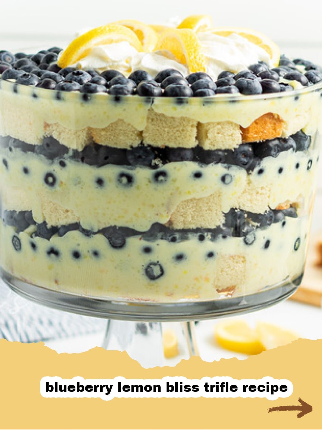 Sunshine in a Glass: The Irresistible Lemon Blueberry Trifle 1 Beautifully layered Lemon Blueberry Trifle in a clear glass bowl, garnished with fresh blueberries and lemon slices, ready to be served.