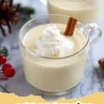 A festive glass of creamy homemade eggnog garnished with nutmeg and a cinnamon stick, ready for the holidays.