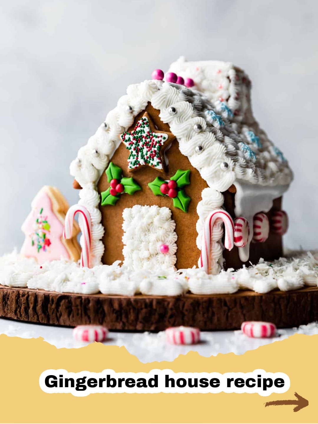 The Ultimate Gingerbread House Recipe (VIDEO) for a Magical Christmas 1 A beautifully decorated, sturdy gingerbread house standing tall on a snowy white base, surrounded by festive candy decorations.