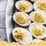 The Secret to Irresistibly Creamy Deviled Eggs: A Family Favorite Recipe 5 A platter of perfectly piped creamy Deviled Eggs garnished with paprika and fresh chives, ready to serve.