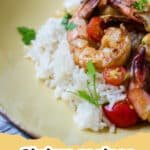 A close-up of a pan of sizzling Quick and Easy Garlic Shrimp, perfectly cooked and coated in a rich garlic butter sauce, garnished with fresh parsley.