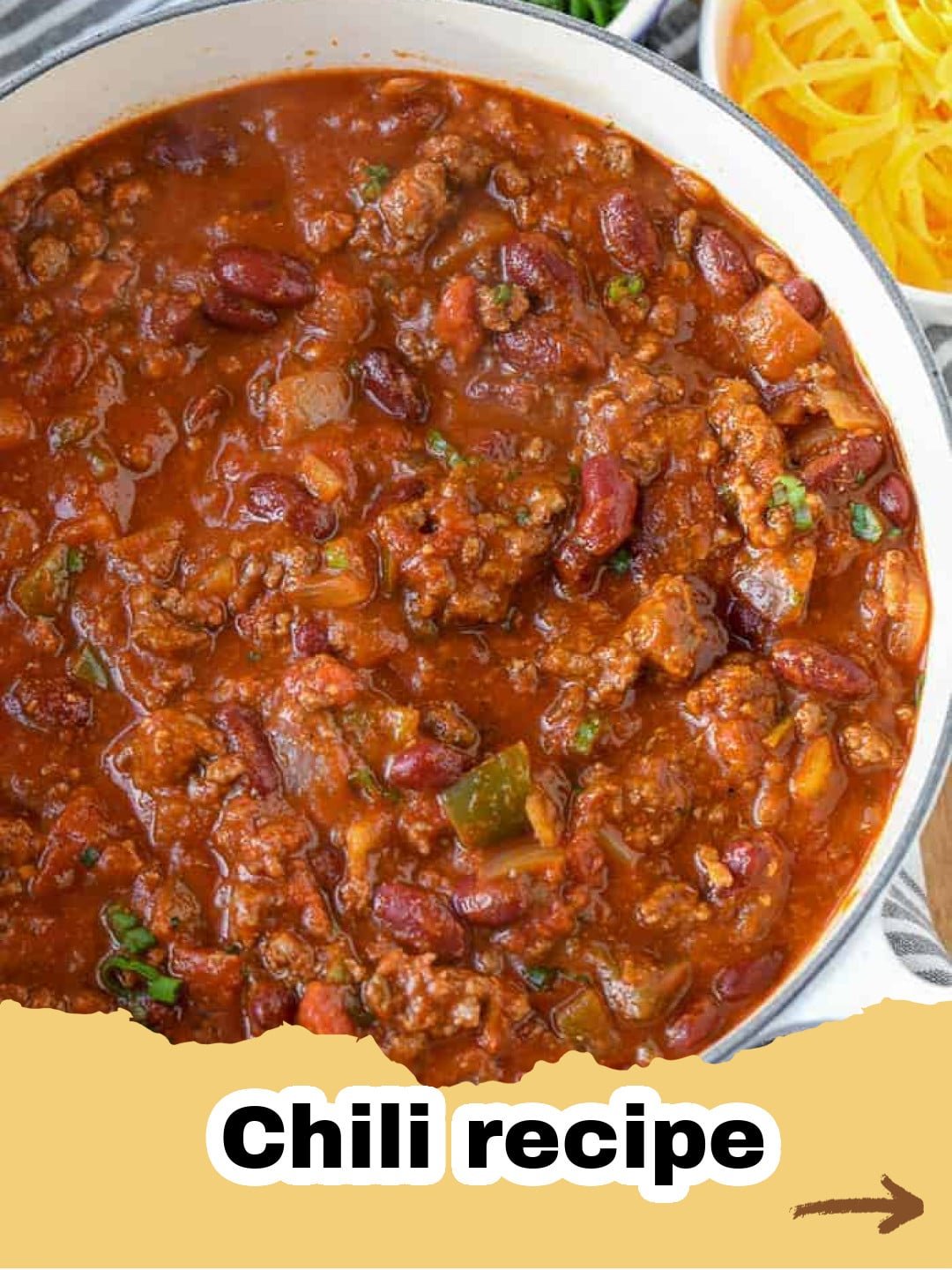 The Ultimate Deep-Dive: Crafting The Best Chili Recipe Ever 1 A close-up of a steaming bowl of homemade chili, garnished with shredded cheddar cheese, a dollop of sour cream, and fresh green onions.