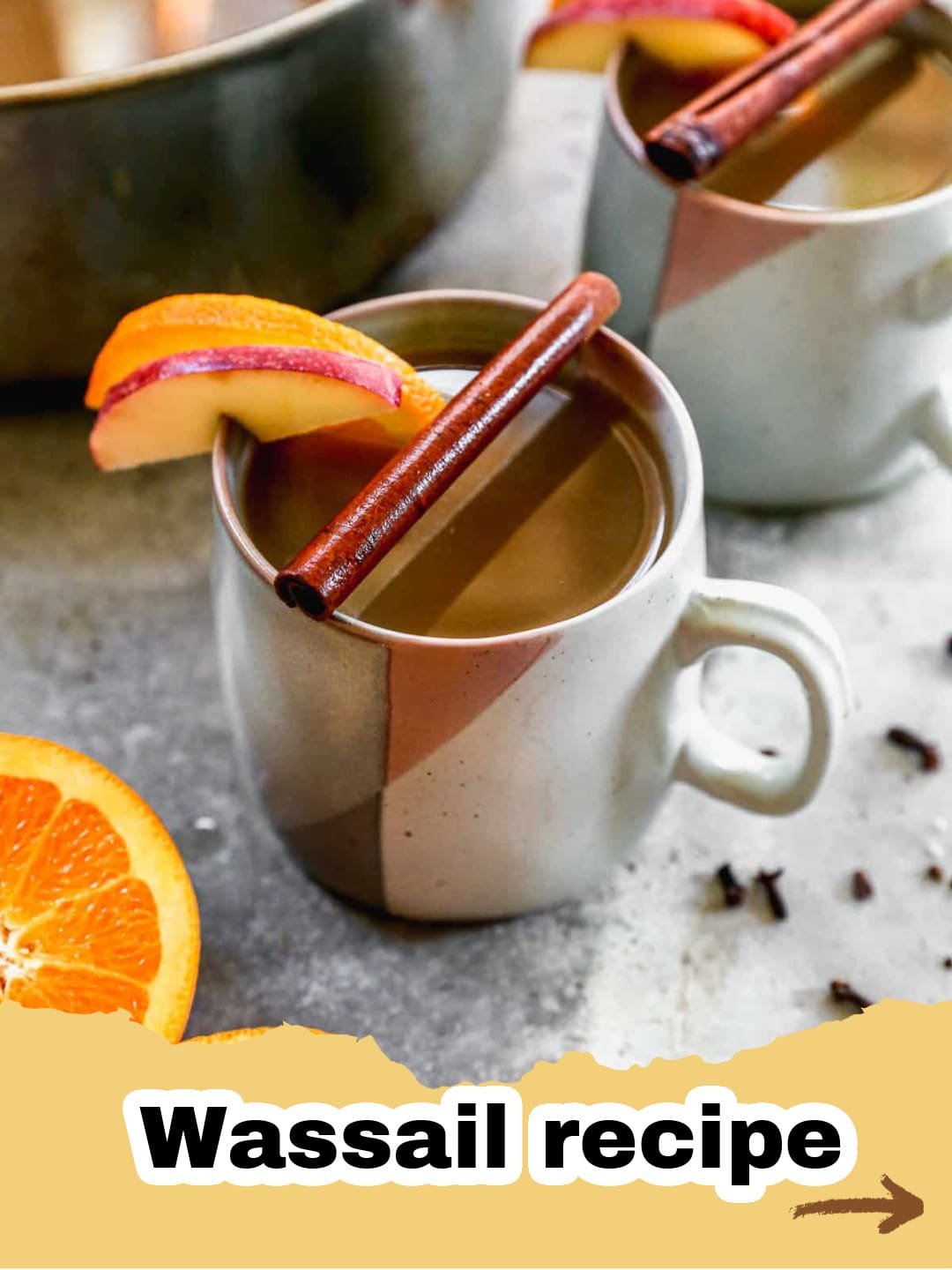 Embrace the Magic: Our Best Traditional Wassail Recipe for the Holidays 1 A steaming mug of traditional Wassail garnished with orange slices and cinnamon sticks on a festive table.