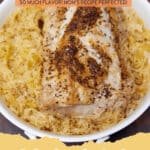 Tender pork roast with golden brown crust, surrounded by tangy sauerkraut, apples, and onions in a Dutch oven, ready to serve.