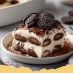 Decadent Chocolate Oreo Tiramisu served in a glass dish, dusted with cocoa powder and garnished with whole Oreos.