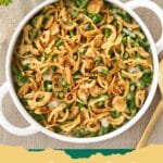 A close up view of a golden brown Green Bean Casserole with crispy onions on top.