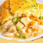 A golden-brown Chicken Cobbler in a glass baking dish with a creamy gravy base.