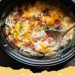 Slow Cooker Crack Chicken served on a bun with melted cheese and bacon