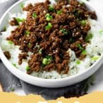 A bowl of Easy Korean Ground Beef served over white rice with green onions and sesame seeds.
