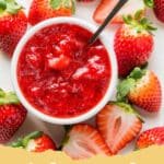 A glass jar filled with vibrant red homemade strawberry sauce