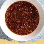 A bowl of rich, dark Bulgogi Sauce with sesame seeds and green onions on top.