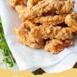 Golden and crunchy crispy fried chicken tenders on a wire rack.