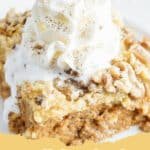 A close up shot of a slice of Pumpkin Pie Dump Cake topped with whipped cream