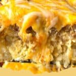 The Ultimate Easy Tater Tot Breakfast Casserole for Any Morning! 5 A golden brown Tater Tot Breakfast Casserole baked in a glass dish, showing crispy tater tots, melted cheese, and sausage, ready to be served.