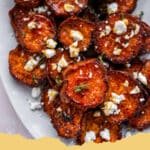 Roasted Sweet Potato Rounds with Honey & Feta: A Perfect Blend of Sweet & Savory 5 Close-up of golden brown Roasted Sweet Potato Rounds with Honey & Feta on a baking sheet, garnished with fresh herbs.