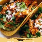 A plate of delicious Chicken Tinga Tacos with cilantro and lime